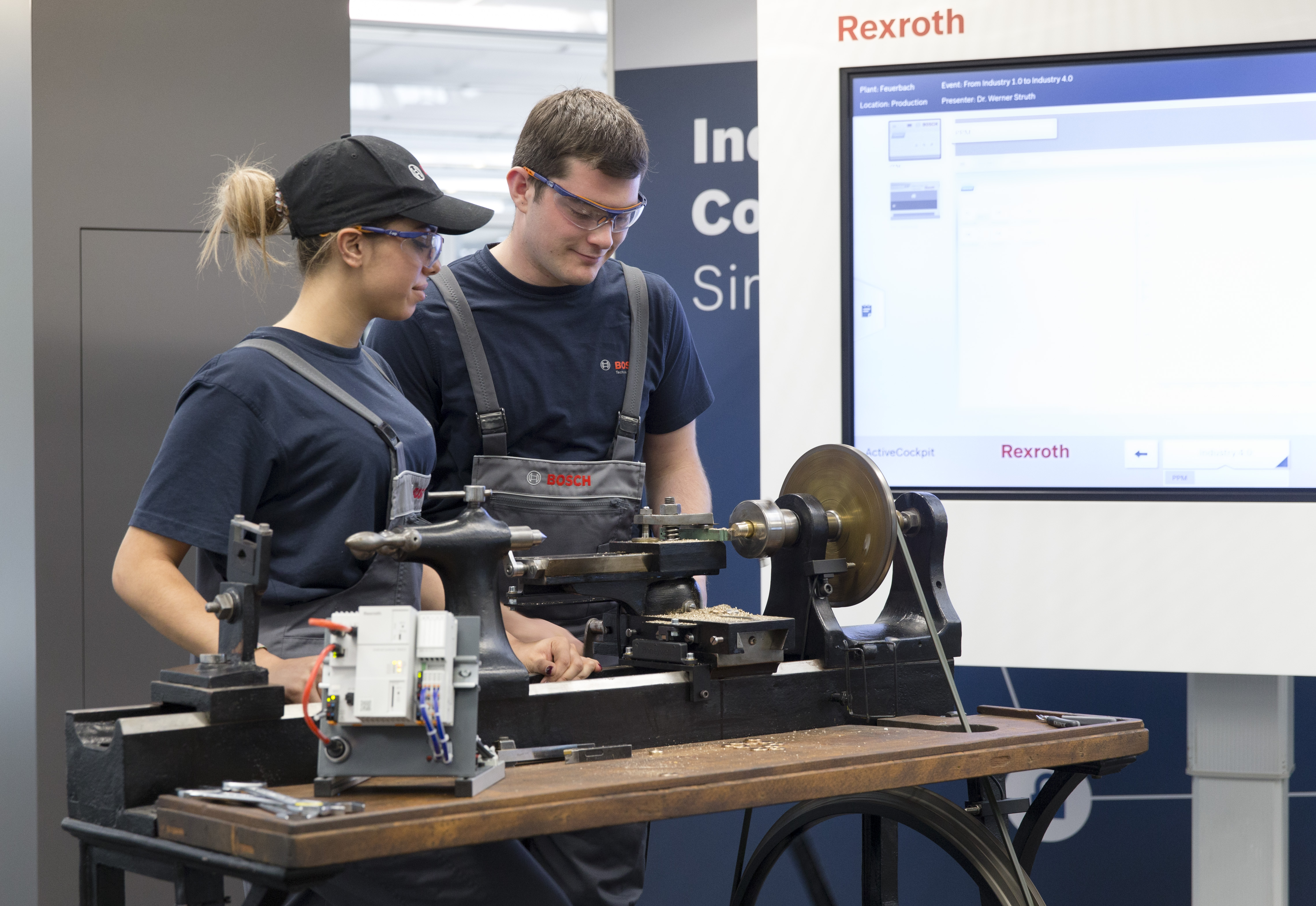 The two Bosch-apprentices Sina Rohloff and Felix Meeh are producing metal parts on the historic lathe from 1887.