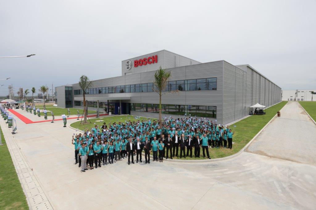 Group photo in front of the new plant